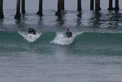 The Chic Ecologist Himself surfing on a small day in San Diego, CA green neoprene